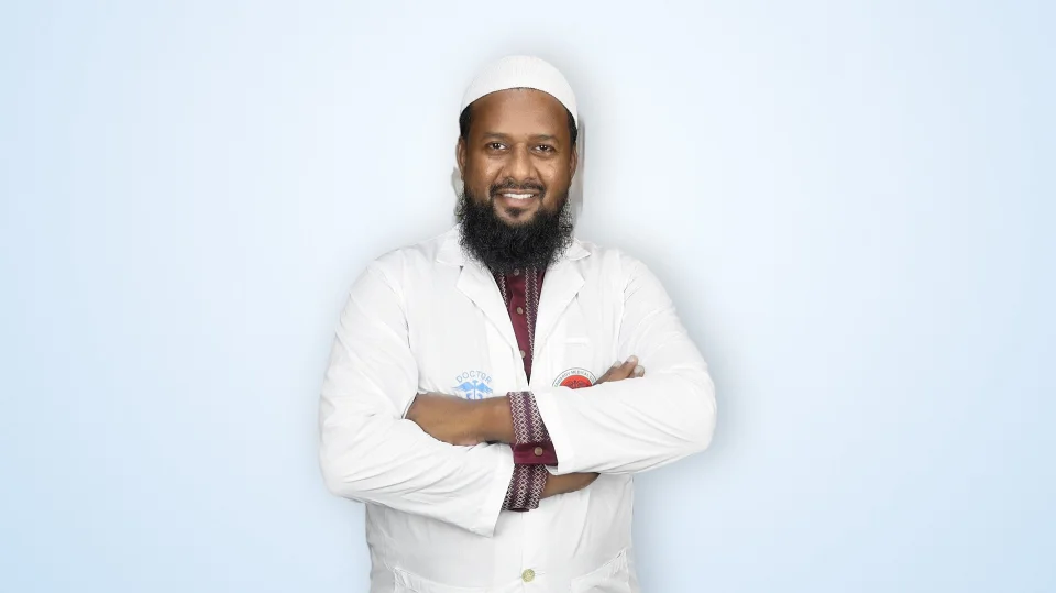 Dr. Tanvir Ahmed in white coat with arms crossed